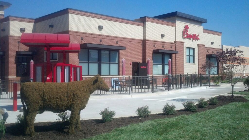 A commercial black metal fence installed around a Chick-fil-A restaurant by Snyders Custom Fencing in York, PA.