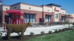 A commercial black metal fence installed around a Chick-fil-A restaurant by Snyders Custom Fencing in York, PA.