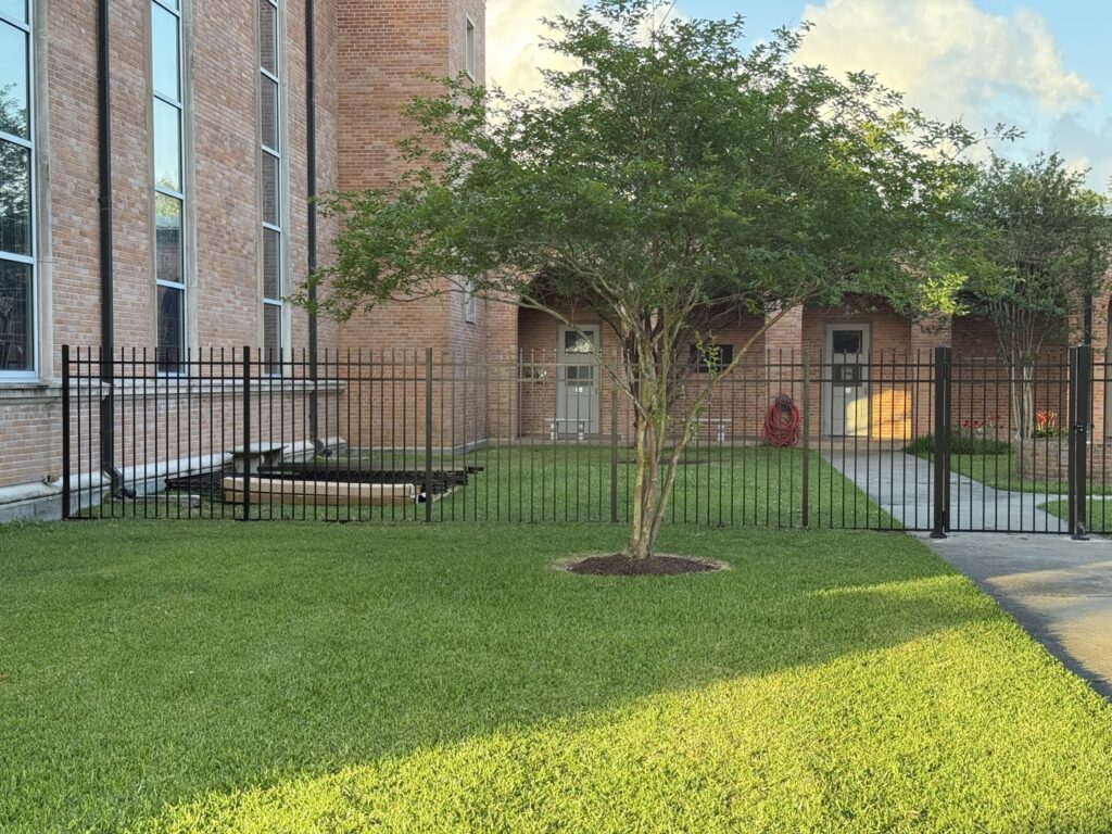 A black metal fence installed around a commercial property or church by Southern Fencing, LLC in Houma, LA.