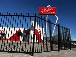 A commercial black metal picket fence surrounding Buffett's Candies, installed by City Iron LLC in Albuquerque, NM.