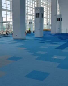 A vast commercial space featuring a striking blue patterned carpet installation by Rugs R Us Corporation in Fort Lauderdale, FL.