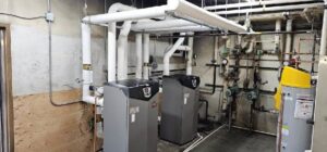 A commercial boiler room with multiple large units and complex piping, serviced by Encode Corporation in Billings, MT.