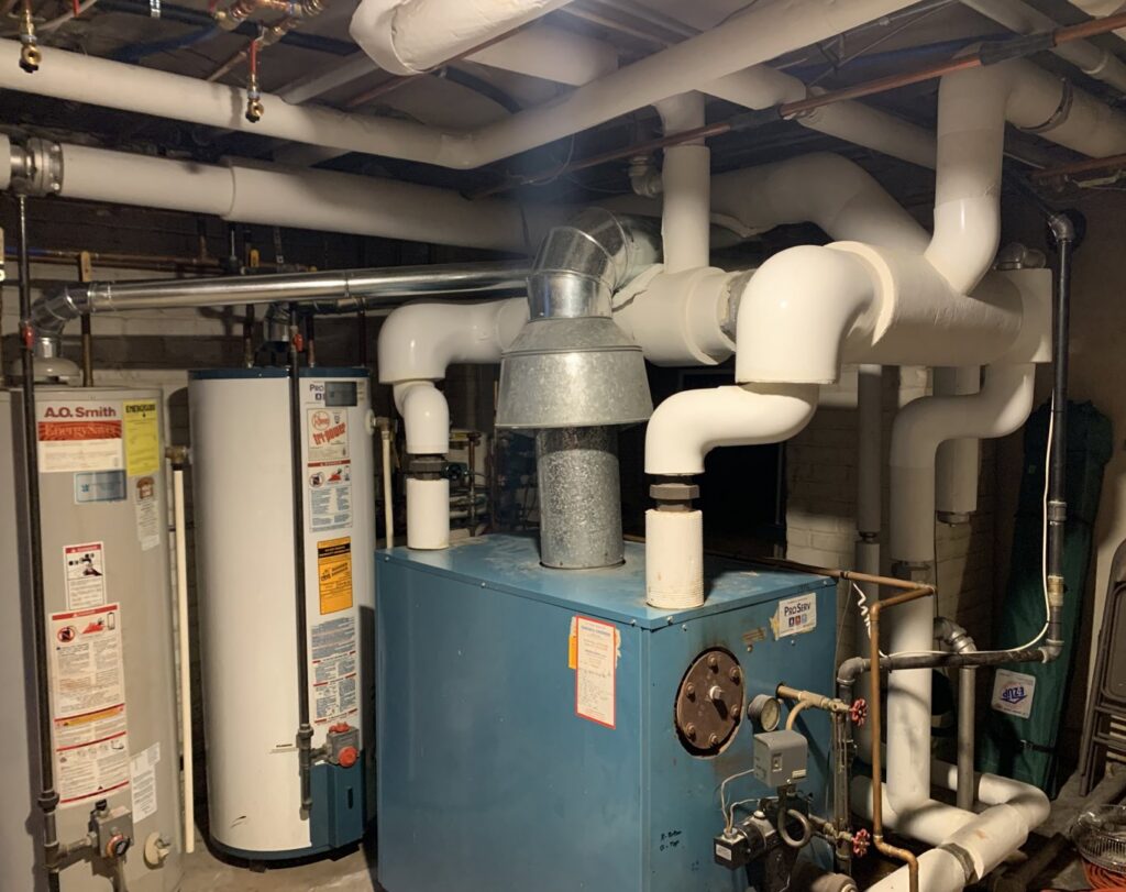 A commercial boiler and multiple water heaters with complex piping installed by 9-1-1 Heating & Air, LLC in Milwaukee, WI.