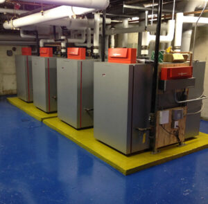 Commercial boilers and heating system in a mechanical room by Accurate Air in Manchester, NH