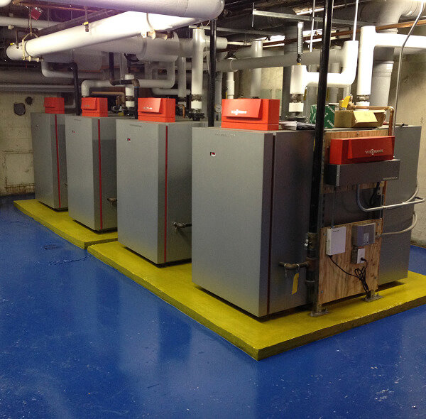 Multiple commercial Viessmann boilers and associated piping in a mechanical room, installed by Accurate Air Inc. in Manchester, NH.