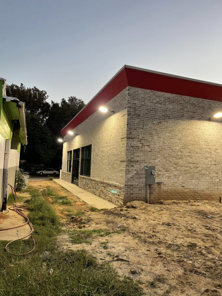 Exterior view of a commercial building with an electrical meter box and wall-mounted lights installed by Leggett Electric LLC in Jackson, TN.