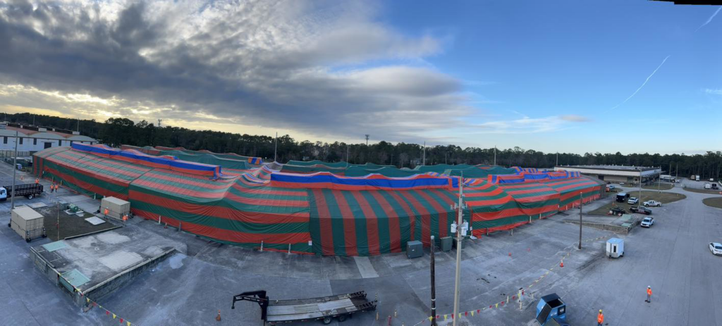 A large commercial building tented for fumigation under a cloudy sky by Rivers Pest Control Service, Inc. in Jacksonville, FL