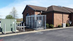 A Generac generator installation completed at a commercial building, enclosed by a fence by Varitech, Inc. in Louisville, KY.