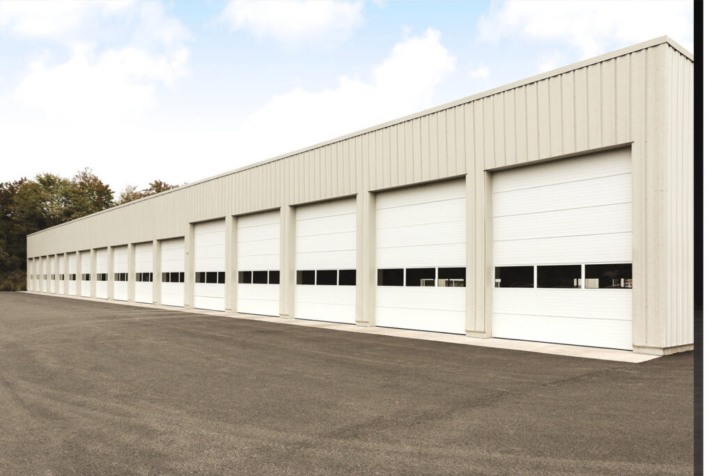 A commercial building featuring multiple overhead garage doors installed by Fort Wayne Door & Dock, Inc. in Fort Wayne, IN