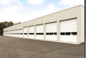 A commercial building featuring multiple overhead garage doors installed by Fort Wayne Door & Dock, Inc. in Fort Wayne, IN