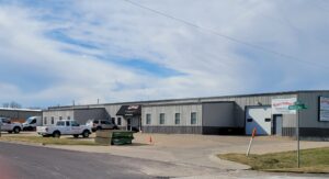 A commercial building featuring multiple roll-up garage doors, installed or serviced by Overhead Door Company of Central Missouri in Columbia, MO.