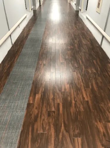 Newly installed commercial carpet and LVT flooring in a hallway by Cavalier Flooring Systems in Richmond, VA.