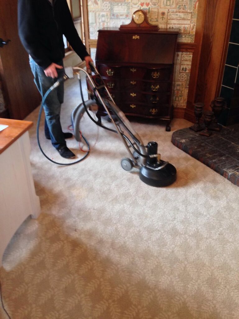 A professional performing commercial carpet cleaning with a machine for AJS Carpet Cleaning, Inc. in Orem, UT.