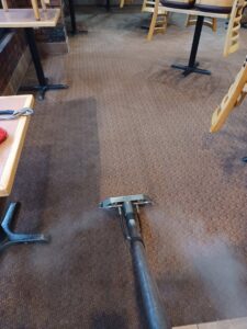 Commercial carpet cleaning showing a clear before and after line by Professional Carpet Systems of Raleigh, NC