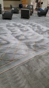 A commercial carpet showing a clear before and after section of professional cleaning by Ziegler Preservation Cleaning in Danbury, CT