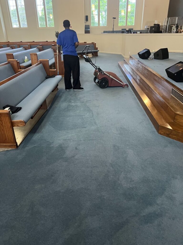 A professional performing commercial carpet cleaning in a church by Word of Mouth Cleaning Services in Houston, TX.
