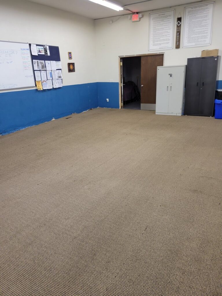 An empty commercial room with carpet, ready for or recently cleaned by Mark's Carpet Cleaning in Omaha, NE