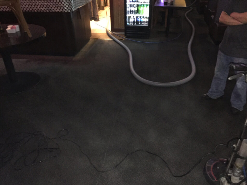Professional carpet cleaning equipment and hoses in a commercial space by C&C Carpet Care LLC in Columbia, MO.