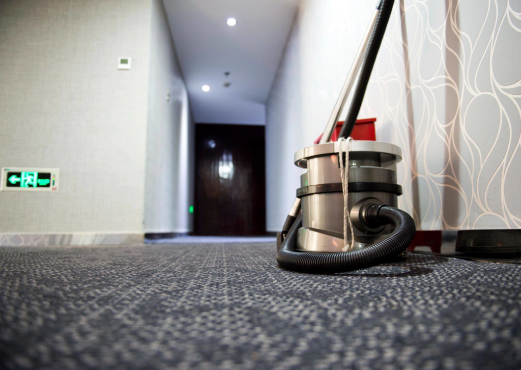 Professional carpet cleaning equipment ready for use in a commercial hallway by Carpet Cleaning & More in Atlanta, GA.