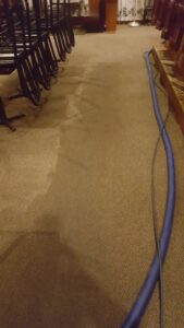 Commercial carpet cleaning in a restaurant with cleaning equipment, showing a clean and dirty section, by Keith's Cleaning Service in Auburn, ME