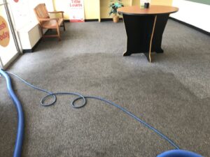 Commercial carpet being cleaned with hoses by Jones Carpet Care LLC in Huntsville, AL.