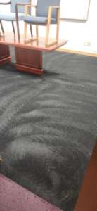 Freshly cleaned commercial carpet with visible cleaning lines by Customer First Carpet Cleaning in Appleton, WI