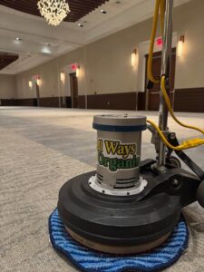 A professional carpet cleaning machine ready for a commercial job in a large empty room by All Ways Organic Citrus Carpet & Upholstery Cleaning in Wilmington, NC.