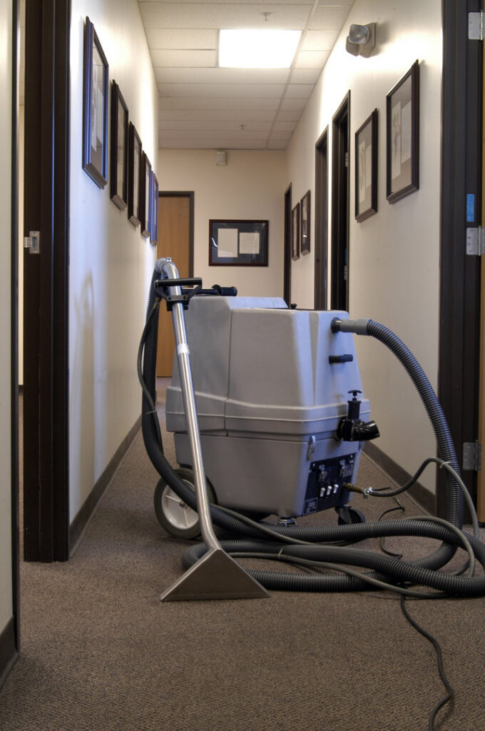 A commercial-grade carpet cleaning machine positioned in a hallway, ready for use by stpaulbestcarpetcleaners.com in Saint Paul, MN.