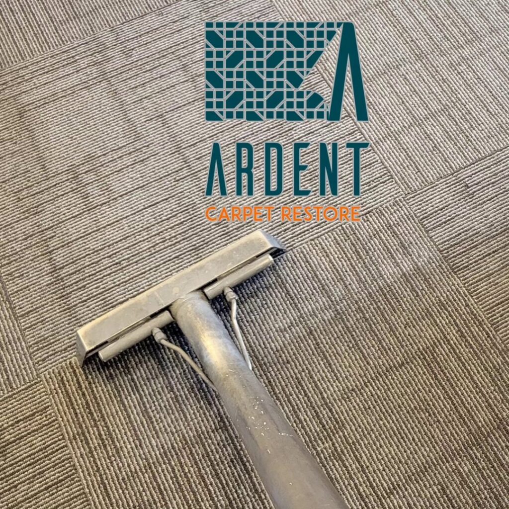 A carpet cleaning wand cleaning a patterned commercial carpet by Ardent Carpet Restore in Sacramento, CA.
