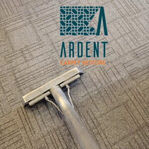 A carpet cleaning wand cleaning a patterned commercial carpet by Ardent Carpet Restore in Sacramento, CA.