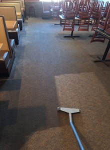 Commercial carpet cleaning in a restaurant, showing a clean and dirty section, by Keith's Cleaning Service in Auburn, ME