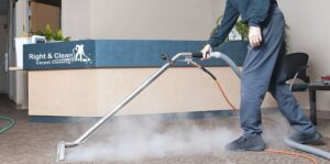 A professional performing commercial carpet cleaning with a steam cleaner for Right & Clean Atlanta 24-7 Carpet Cleaning in Atlanta, GA.