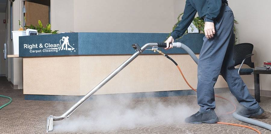 A professional performing commercial carpet cleaning with a steam cleaner for Right & Clean Atlanta 24-7 Carpet Cleaning in Atlanta, GA.