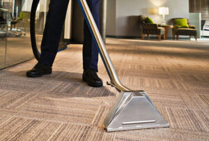 A professional from Muscle Cleaning Services performing commercial carpet cleaning in Dallas, TX.