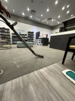 A professional cleaning commercial carpet in a retail space by Precise Carpet Care in Albuquerque, NM.