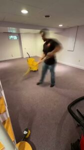 A worker performing commercial carpet cleaning with equipment for Two Sheas Restoration in Tulsa, OK.