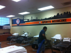 Technician performing commercial carpet cleaning in a sports medicine facility by Apex Carpet Cleaning & Flood Restoration LLC, Phoenix, AZ