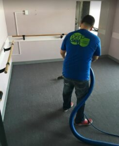 A professional cleaning commercial carpet in a studio setting by DEEP CLEAN Carpet Cleaners in Beaverton, OR
