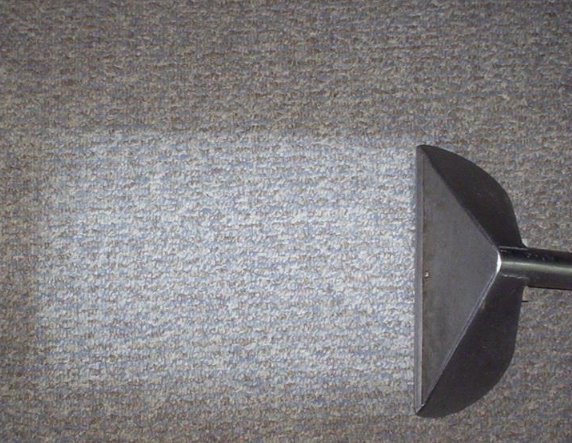 Commercial carpet cleaning in progress, showing a clean strip on a grey carpet by Superior Carpet Cleaning in Greenville, SC.