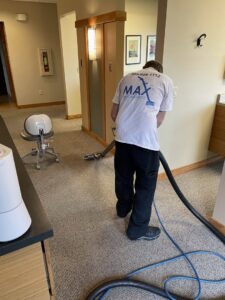 A technician from Max Performance Carpet Cleaning performing commercial carpet cleaning in Spokane, WA.