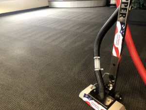Professional carpet cleaning tool in use on commercial carpet by Allen Rapid Dry Carpet Cleaning in Anchorage, AK.