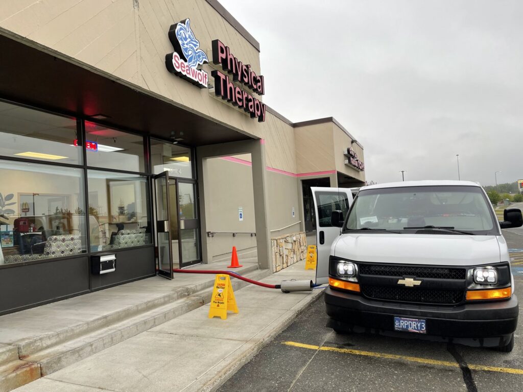 Allen Rapid Dry Carpet Cleaning van parked outside a commercial building during a job in Anchorage, AK.