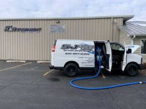 S&J Carpet Care van with hoses extended for commercial carpet cleaning at MAB Equipment Company in Oswego, IL