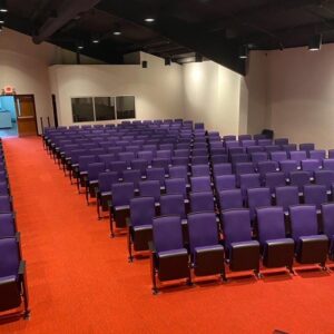 A large auditorium with new orange commercial carpet installed by Metro Flooring Company in Jeffersontown, KY