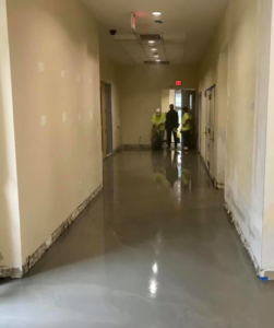A large commercial room with new patterned carpet being installed by David Cox Flooring in Bridgewater, MA.