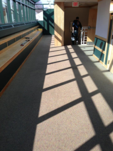 A newly installed commercial carpet in a long hallway by Belmont Flooring in Boston, MA