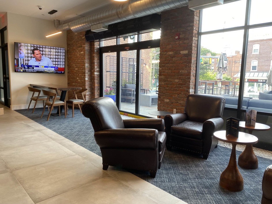 A modern lounge area featuring a newly installed blue patterned carpet by Carpet & Wood Floor Liquidators in Baltimore, MD.