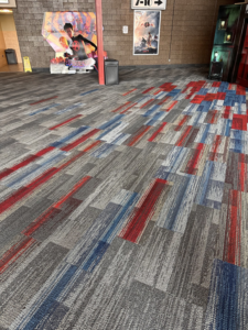 A vibrant commercial carpet installation featuring red, blue, and grey patterns by National Lift Installation Inc in Franklin, TN.