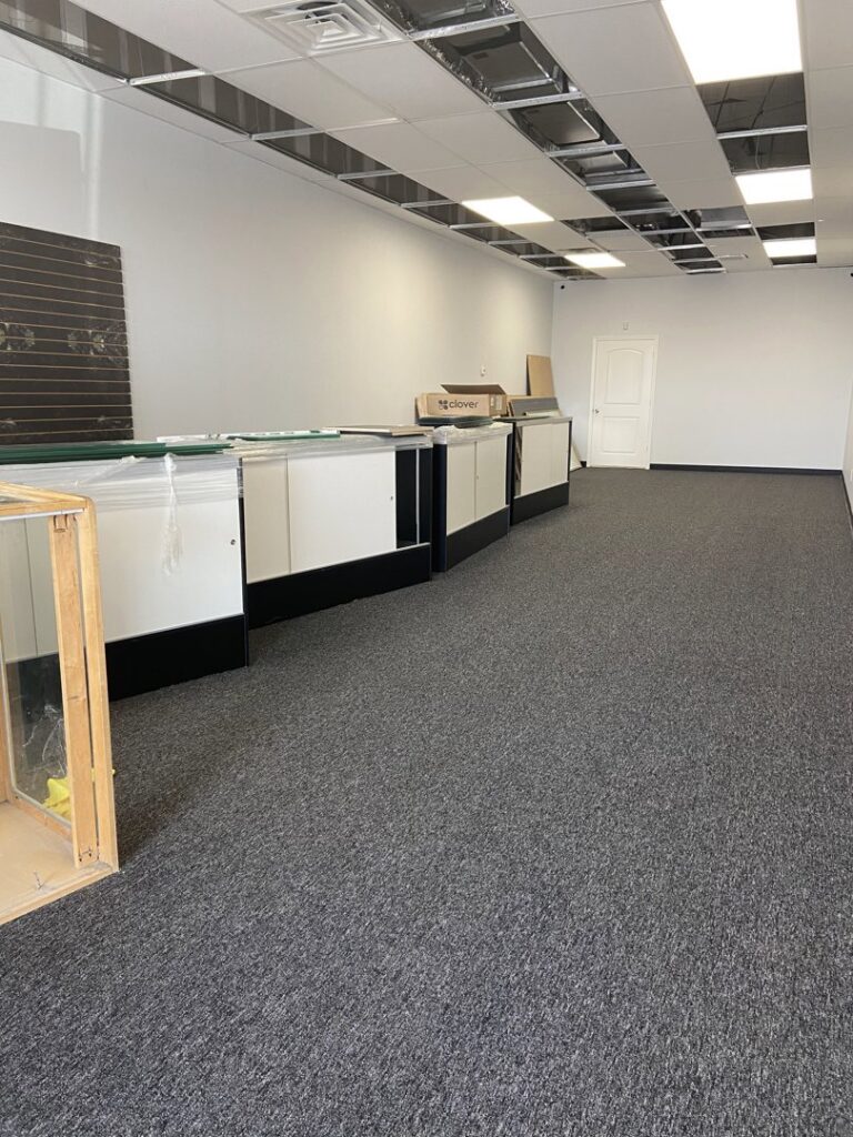 Commercial carpet installation in a retail or office space with dark gray carpet by Castro's Carpet in Houston, TX.