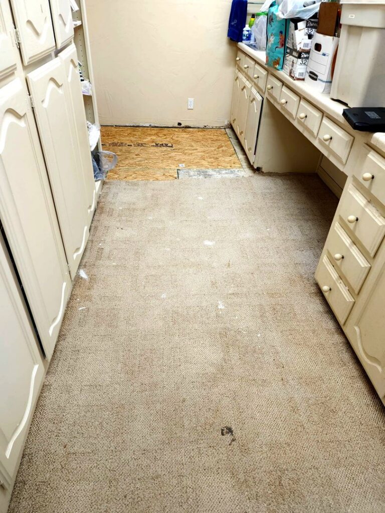 Old commercial carpet removed from a courtroom, exposing the subfloor, demonstrating a carpet removal service by Affordable Carpet & Flooring in Dallas, TX.